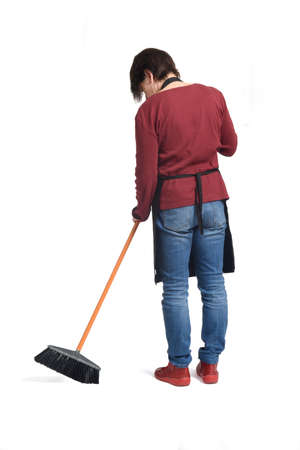 back view of a woman sweeping on white backgroundの写真素材