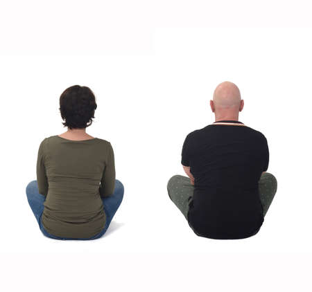 rear view of a woman and man sitting on the floor isolated on whiteの写真素材