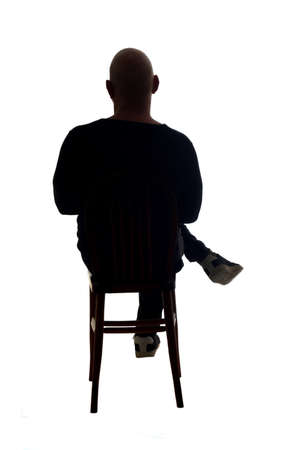 silhouette of the same man sittingの写真素材