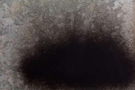black spray paint on galvanized sheet metalの写真素材
