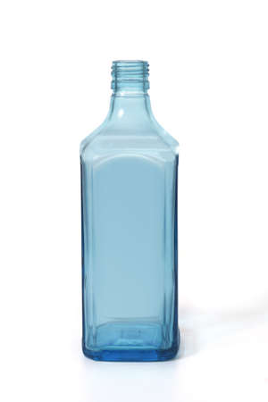 blue glass bottle of dry gin standing on white backgroundの写真素材