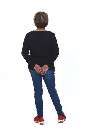 rear view of full portrait of a senior woman with hand on back on white backgroundの写真素材