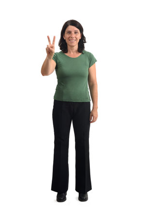 front view of a woman showing victory sign with fingers on white backgroundの写真素材