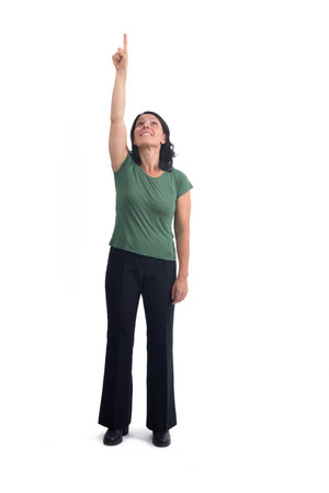 front view of a woman pointing up and looking up on white backgroundの写真素材