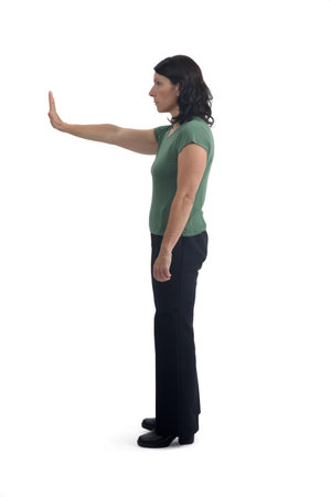 side view of a woman showing the stop sign with their hands on white backgroundの写真素材