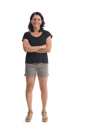 front view of a woman with shorts amrs crossed and looking at camera on white backgroundの写真素材