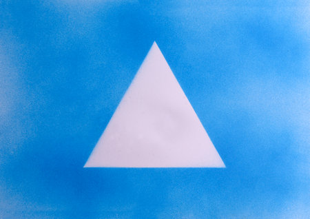 blue spray paint triangle on paperの写真素材