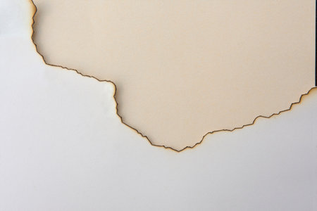white burnt paper with cream backgroundの写真素材