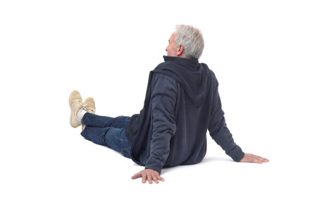 back side view of a man sitting on the floor on white backgroundの写真素材