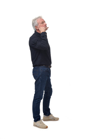 man making phone gesture with his hands and looking up white backgroundの写真素材