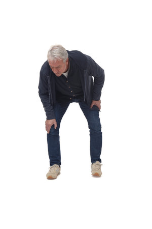 full portrait of front view of a man crouching down and looking at the floor on white backgroundの写真素材