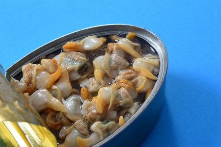 can of cockles on blue backgroundの写真素材