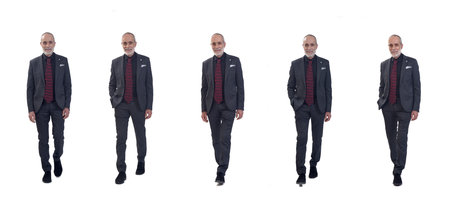 front view of a group of same man walking with suit and tie on white backgroundの写真素材
