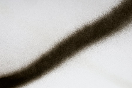 diagonal black line of spray paint on white paperの写真素材