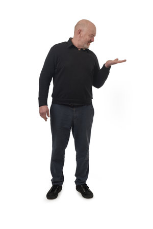 front view of a man showing an imaginary object in his hand on white background.の写真素材