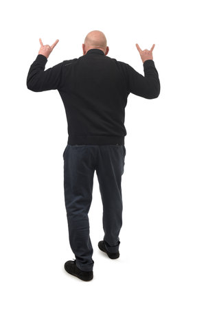 rear view of a man showing the horns sign with fingers on white backgroundの写真素材
