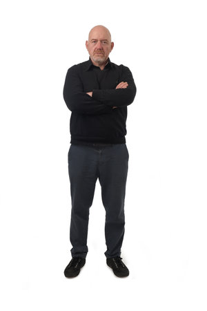 front view of a serious man looking at camera and arms crossed on white backgroundの写真素材