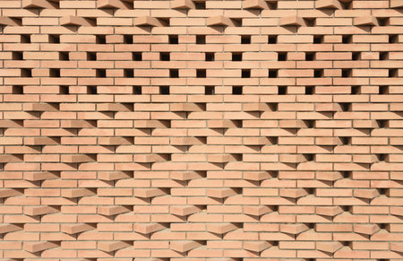 wall texture with protruding bricks illuminated by the sun