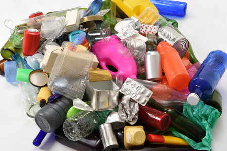 elevated view of a group of plastic, glass and cans containers isolated on white background