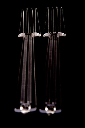 two fors plastic on black background