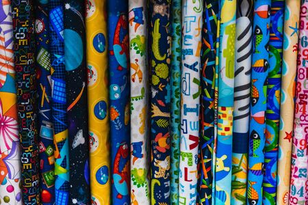 Several fabrics in different colors and patterns for child