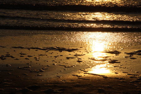 The pattern of waves in the sea during the sunset on the beach.の写真素材