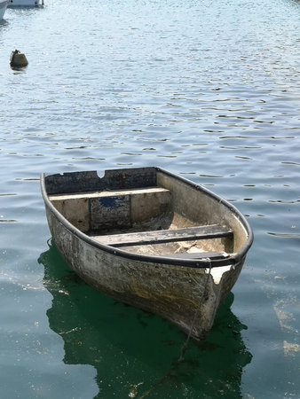 A small empty bobbing boat on undulating water.の写真素材