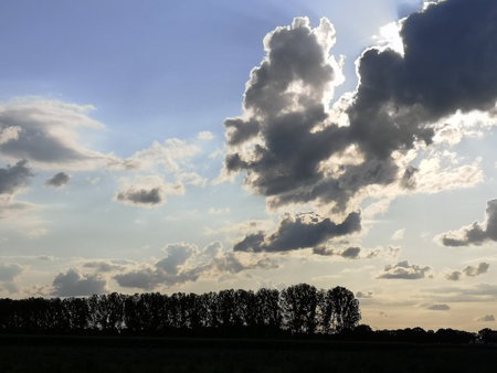 Cloudy sky in the evening twilight. Dark clouds. Dutch sky. The Netherlands, Europe.の写真素材