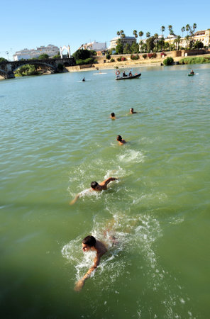 Children and teenagers swimming in the river of Sevilleのeditorial素材