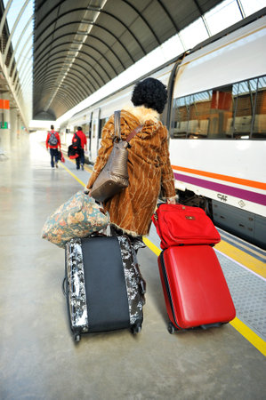 Woman with bags in the train station in Seville, Spainのeditorial素材
