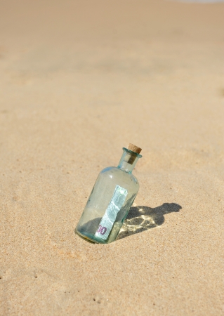 Hundred euros in the bottle on the beachの写真素材