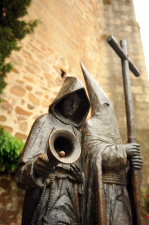 Nazarenes with cross, bronze sculpture, Holy Week in Caceres, Extremadura, Spain