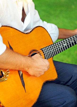 Musician playing spanish guitar outdoorの写真素材
