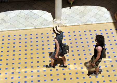 Two tourists, young couple walking through an Andalusian courtyard view from aboveのeditorial素材