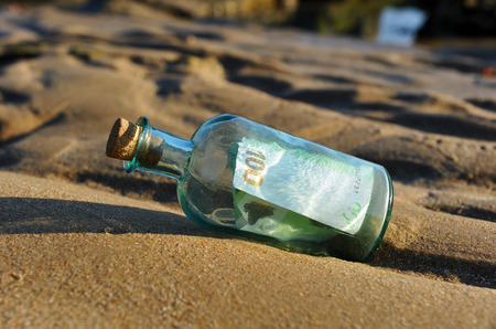 100 euro banknote in a bottle found on the beachの写真素材
