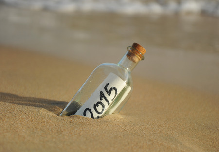 Happy new year, 2015, bottle with message on the sand beachの写真素材