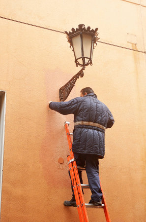 Electrician repairing a streetlightの写真素材