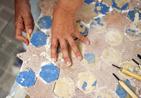 Woman restoring an ancient pavement starsの写真素材