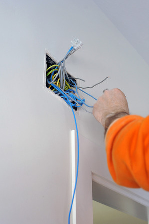 Electrician connecting the wiring during the renovation of the houseの写真素材