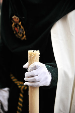 Nazarene with candle in hand, Holy Week in Seville, Andalusia, Spainのeditorial素材