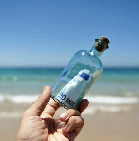 20 euro banknote in a bottle on the handの写真素材
