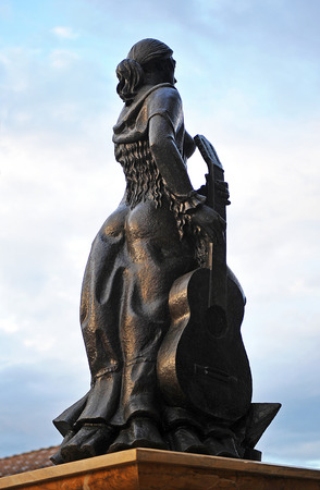 Andalusian woman with guitar in the neighborhood of Triana, Tribute to flamenco, Seville, Spainの写真素材