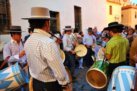 Men playing the drum and flute during the pilgrimage of Rocio, streets in the neighborhood of...