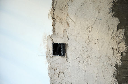 Installing an electrical box for power sockets on the wallの写真素材