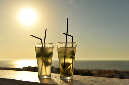 Mojito at sunset on a beach barの写真素材