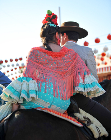 Feast in Spain, young couple riding in the Seville Fair, springtimeの写真素材