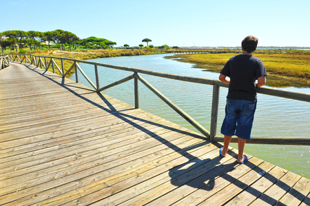 A boy at the Piedras River marshes, El Rompido, Huelva, Andalusia, Spainの写真素材