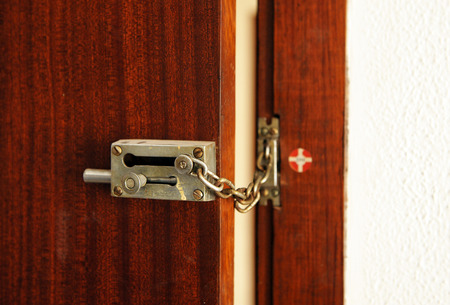 Entrance door of the house with safety chain and lock