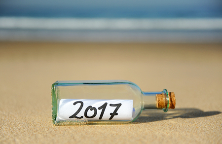 New year party, bottle with message on the beach, 2017の写真素材