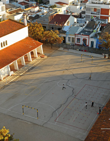 Children playing in the playground of a public elementary school at sunset, Portugal, southern Europeのeditorial素材